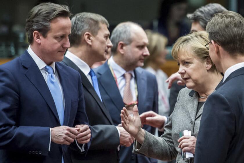 British Prime Minister David Cameron, left, speaks with Finland's prime minister, Jyrki Tapani Katainen, right, and German Chancellor Angela Merkel, second right, during a round-table meeting at a European Union gathering in Brussels.