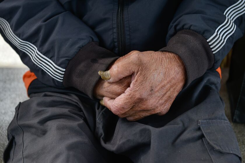 TAIWAN, Taipei: Detail of the hands of homeless 73-year old Jimmy BAI, in central Taipei's 228 Peace Park. 17th February 2020. Credit: Chris Stowers