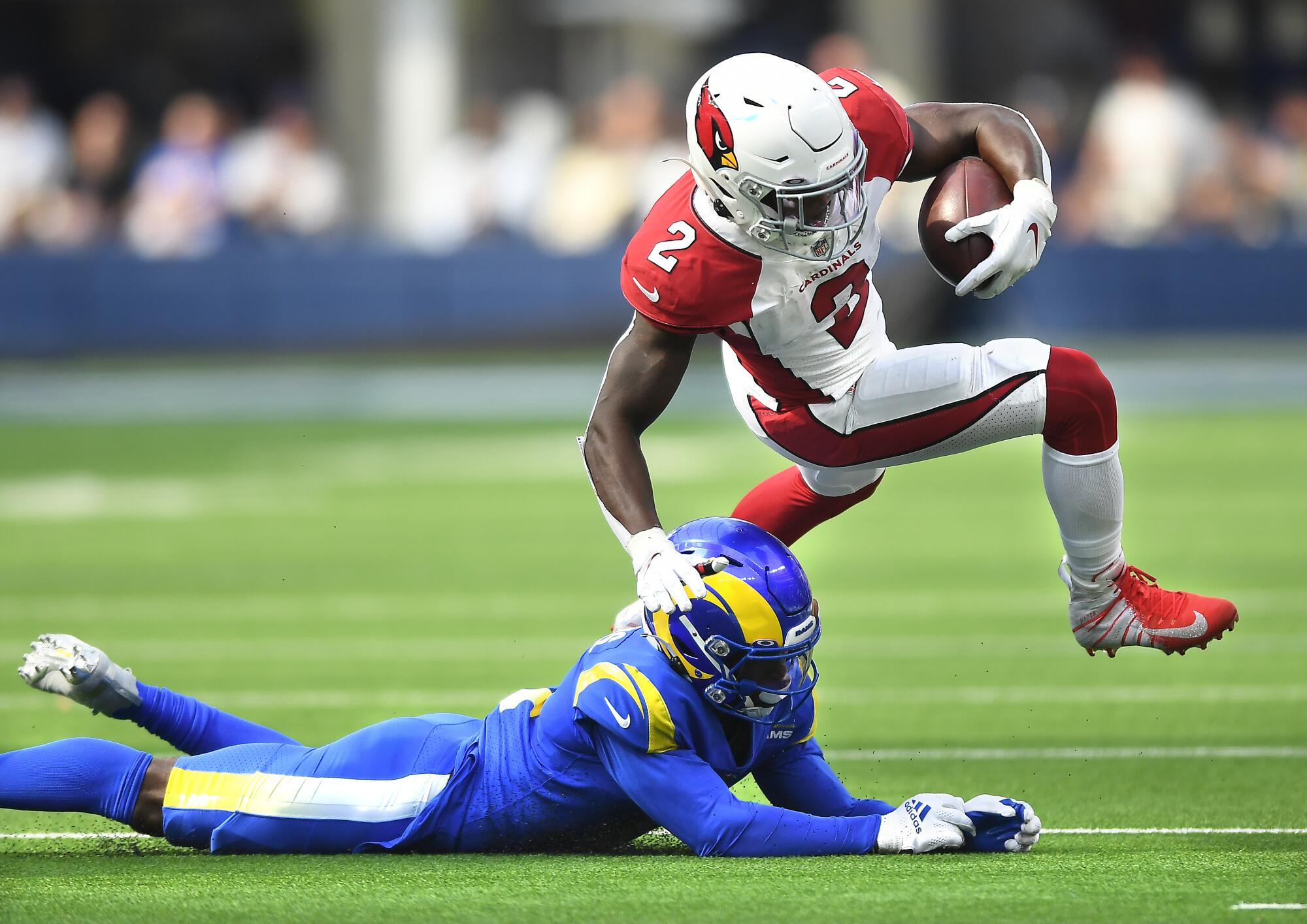 Arizona Cardinals running back Chase Edmonds is brought down by Rams cornerback Darious Williams.
