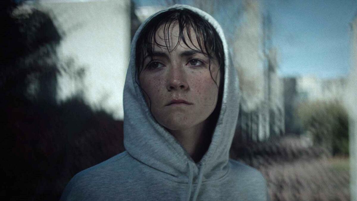 A woman in a hoodie in “The Novice.”
