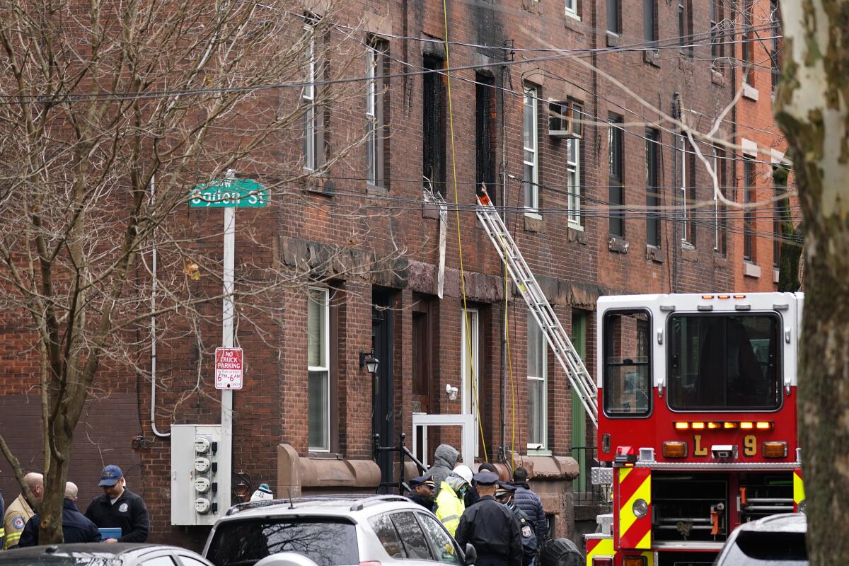 A fire truck and first responders at a row home