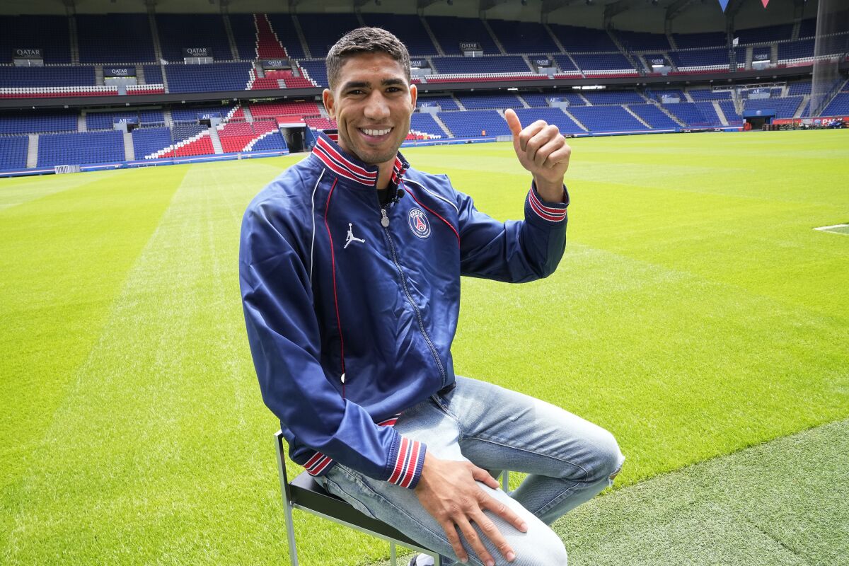 Former Inter Milan's Achraf Hakimi thumbs up during an interview at the Parc des Princes stadium, Thursday, July 8, 2021 in Paris. Paris Saint-Germain have stepped up their recruitment by signing the Inter full-back Achraf Hakimi, with Sergio Ramos. PSG is also reportedly set to sign Italy goalkeeper Gianluigi Donnarumma after the European Championship. (AP Photo/Michel Euler)