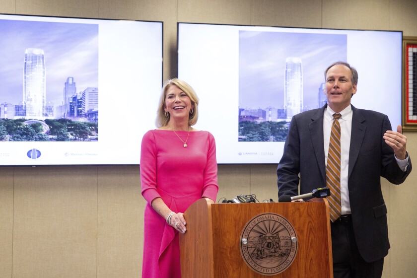 Omaha Mayor Jean Stothert, left, and Mutual of Omaha CEO James Blackledge announce plans for a new Mutual of Omaha headquarters skyscraper on the site of the current downtown library, Wednesday, Jan. 26, 2022. Many companies are recommitting to office space and moving forward with major projects because they believe working in person is better for collaboration and training younger employees. The plans also include building a three-mile streetcar system that would run from the riverfront to Nebraska Medicine. (Anna Reed/Omaha World-Herald via AP)