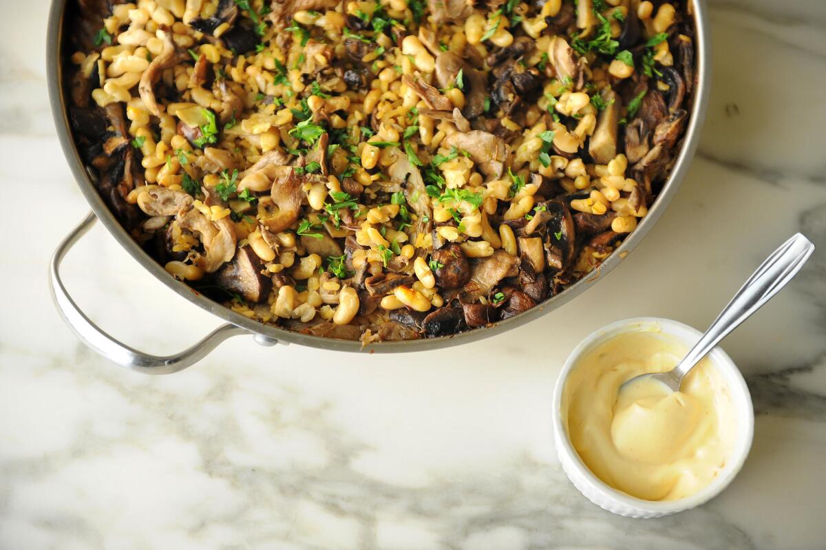 overhead shot of paella in paella pan and sauce
