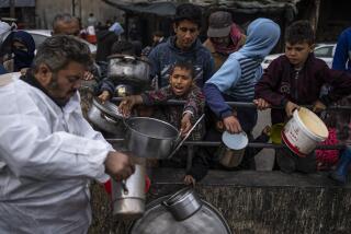 Palestinians line up for free food in Rafah, Gaza Strip, Friday, Feb. 23, 2024. An estimated 1.5 million Palestinians displaced by the war took refuge in Rafahor, which is likely Israel's next focus in its war against Hamas.(AP Photo/Fatima Shbair)