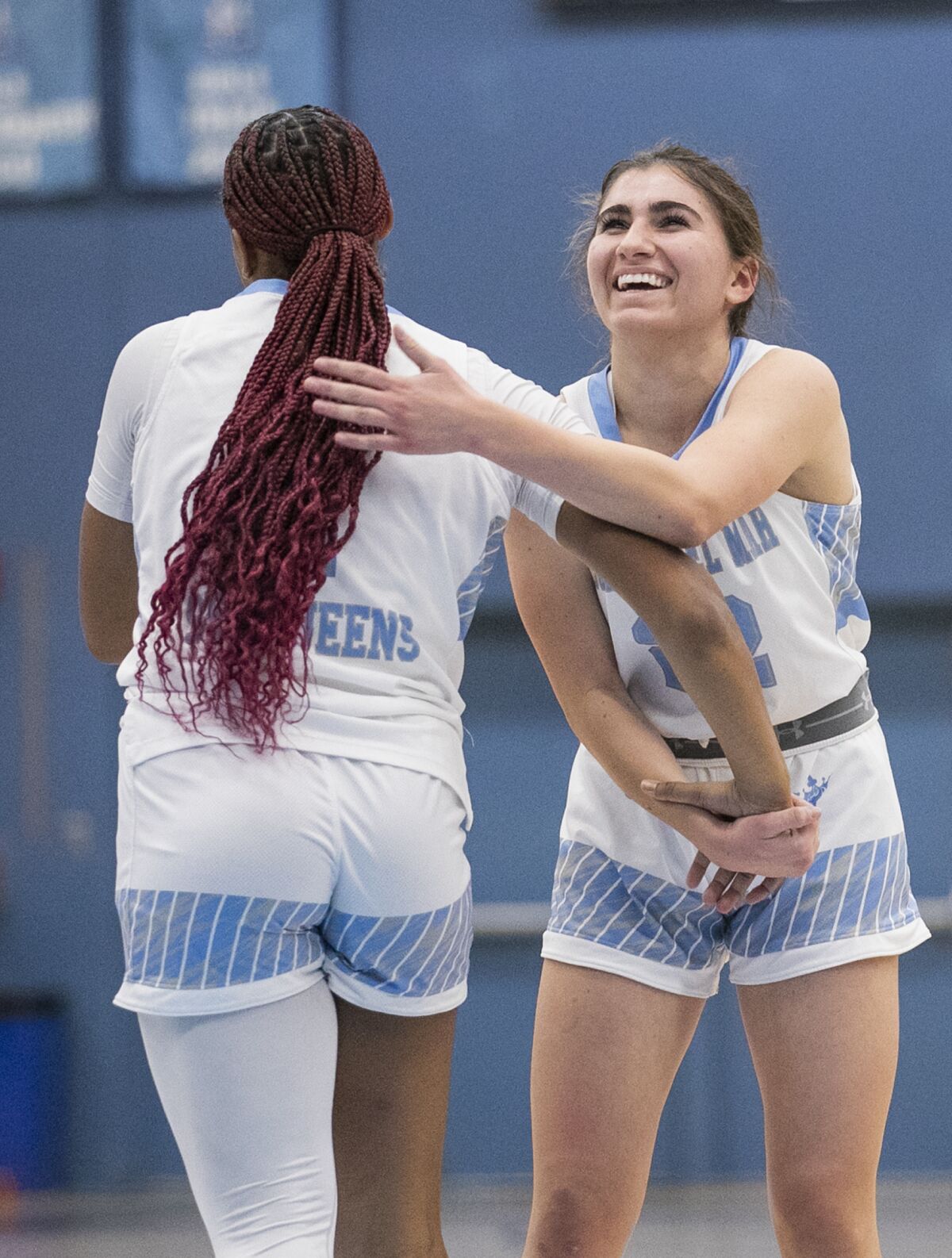 Corona del Mar's Kenedie French-Matthews, left, celebrates with Julia Mork, right, during a game against Newport Harbor.