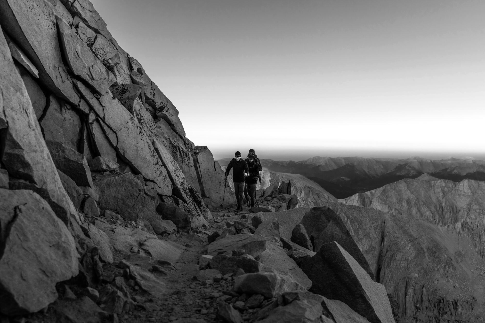 Hikers on on a rocky mountain trail.