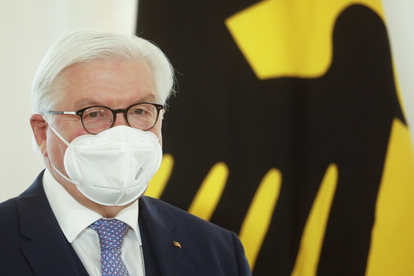FILE - In this March 26, 2021 file photo, German President Frank Walter Steinmeier attends a ceremony to honor people for their services during the coronavirus pandemic with state's cross of merit at Bellevue Palace in Berlin, Germany. Germany’s president appealed to hesitant compatriots on Wednesday to get vaccinated against COVID-19, adding to efforts by top politicians to reinvigorate the country's inoculation campaign as case numbers have begun to creep higher. (AP Photo/Markus Schreiber, File)