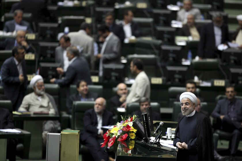 Iranian President Hassan Rouhani, shown in this file photo from an Iranian parliamentary address last month, plans to take his case for sanctions relief to the U.N. General Assembly in New York this week.
