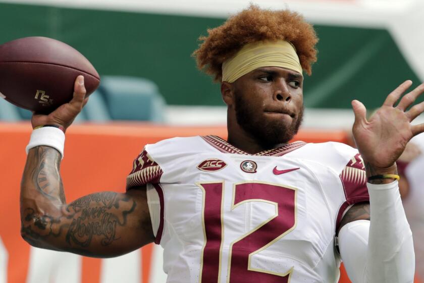 FILE - In this Saturday, Oct. 6, 2018, file photo, Florida State quarterback Deondre Francois (12) warms up before an NCAA college football game against Miami, in Miami Gardens, Fla. Florida State head football coach Willie Taggart announced Sunday, Feb. 3, 2019, that Francois has been dismissed from the team after allegations of domestic abuse surfaced. (AP Photo/Lynne Sladky, File)