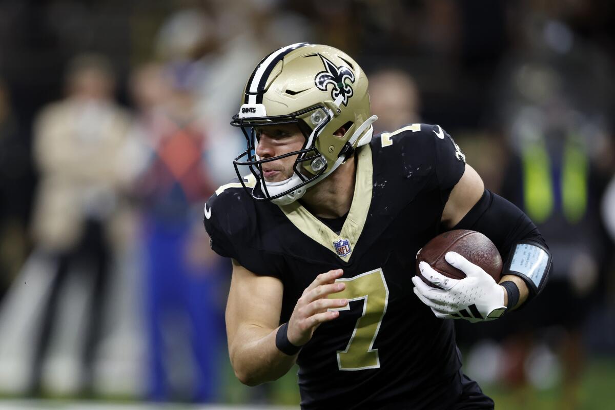 New Orleans Saints tight end Taysom Hill carries the ball against the Tennessee Titans.