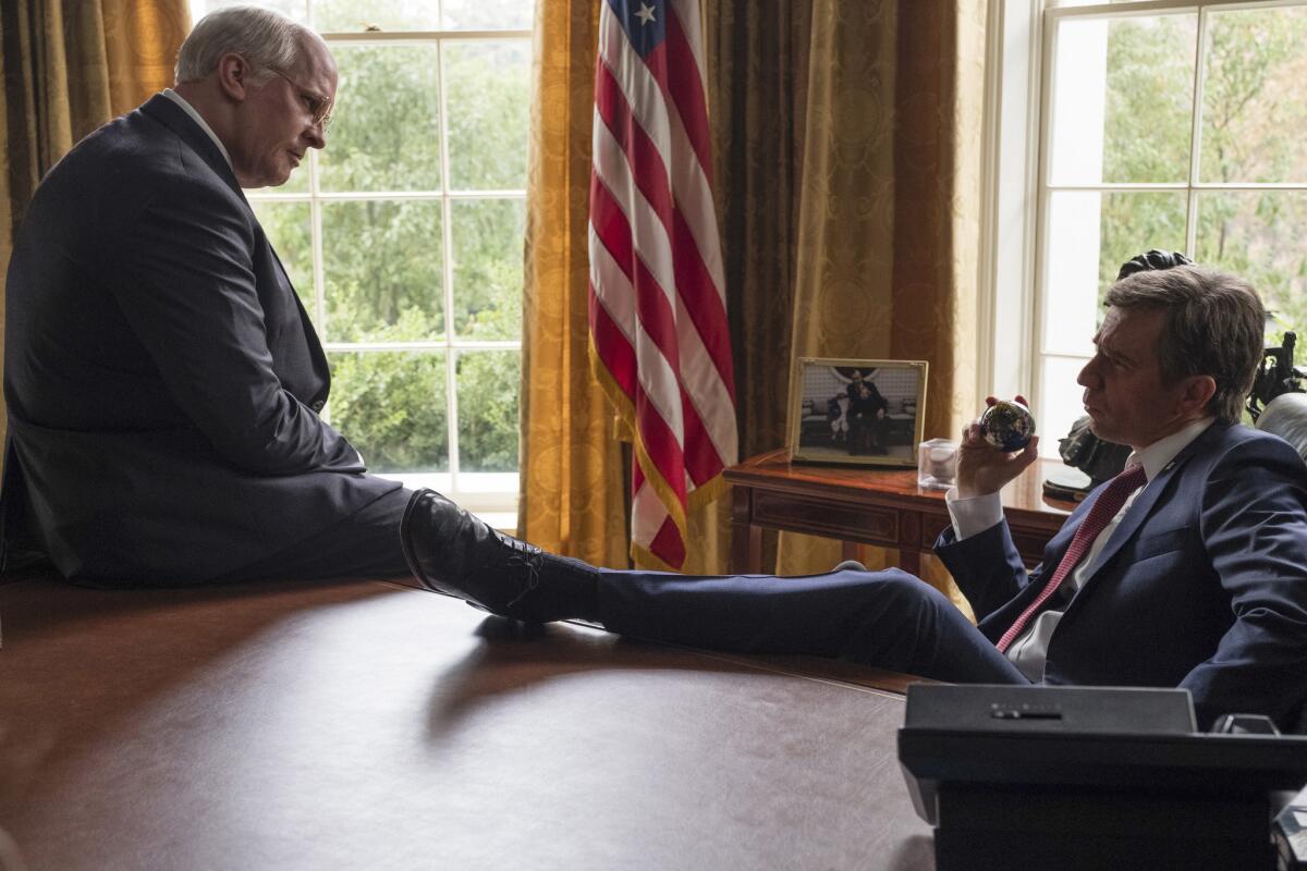 Christian Bale, left, as Dick Cheney and Sam Rockwell as George W. Bush in a scene from Adam McKay's "Vice."
