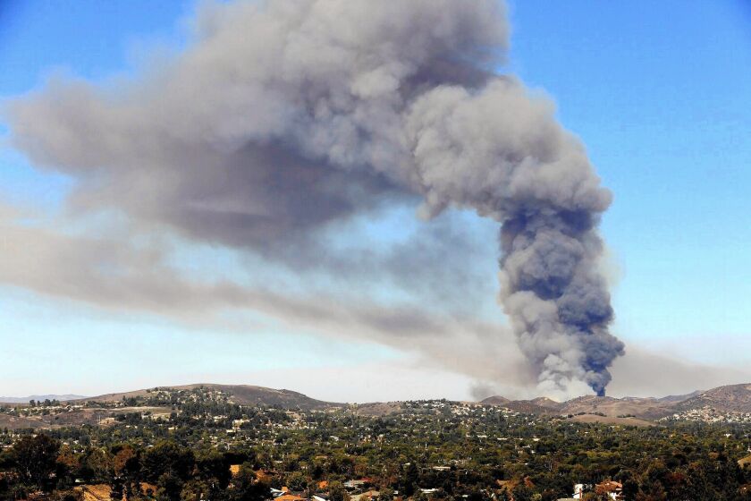 Smoke seen from Thousand Oaks rises from a brush fire in the hills of Simi Valley. By late Friday, it had charred more than 180 acres.