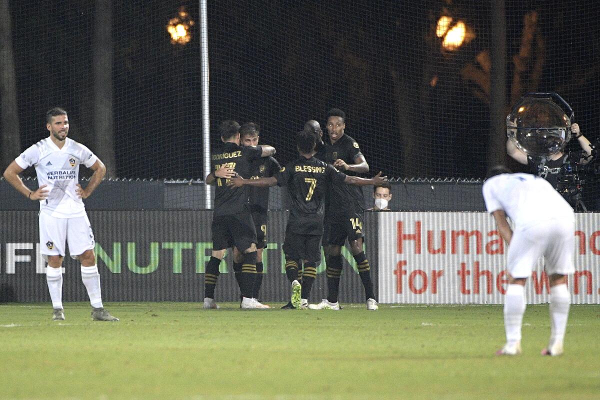 Los Angeles FC forward Diego Rossi (9) is congratulated by teammates after scoring a goal.