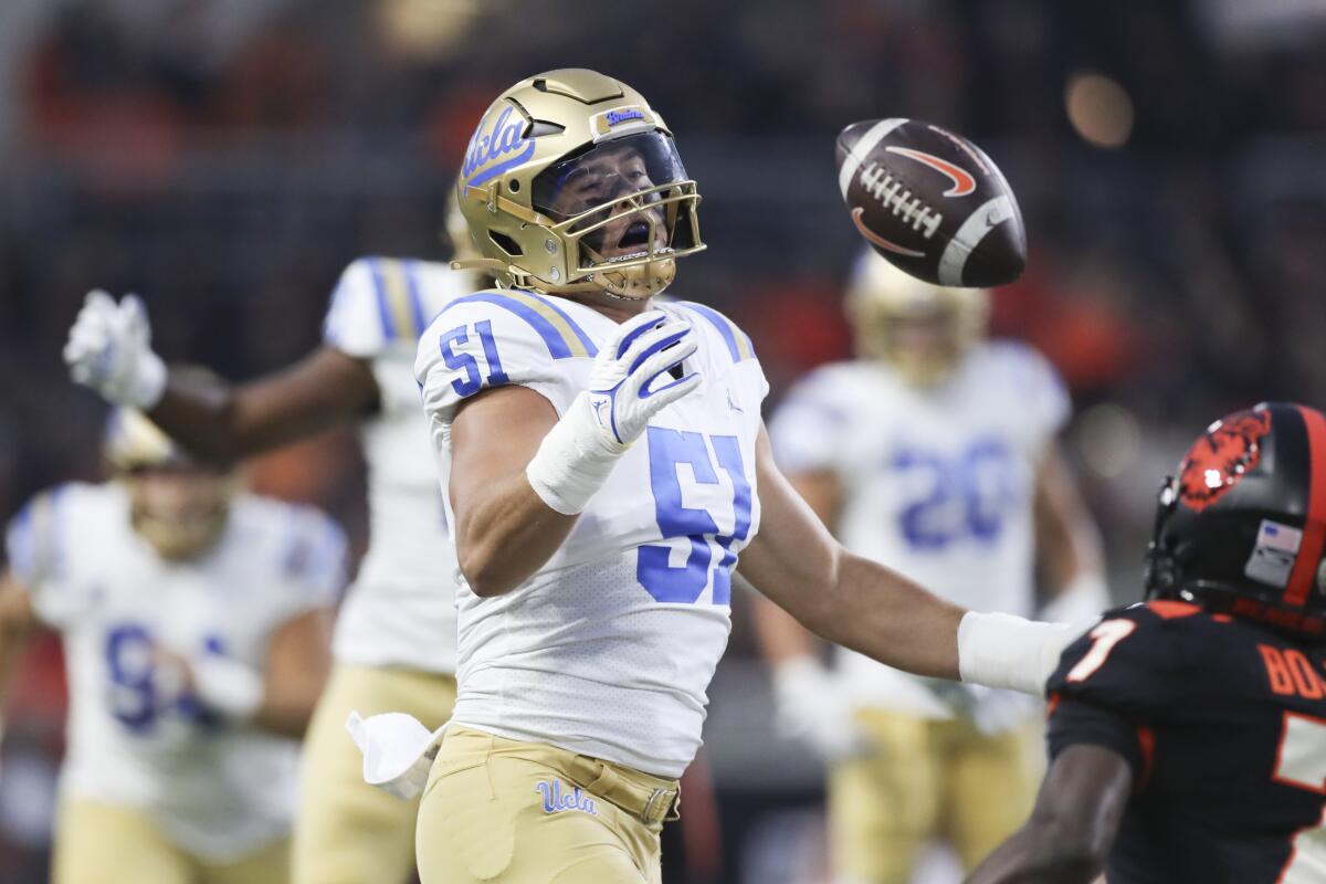 UCLA defensive lineman Jake Heimlicher can't quite pick off a pass intended for Oregon State wide receiver Silas Bolden.