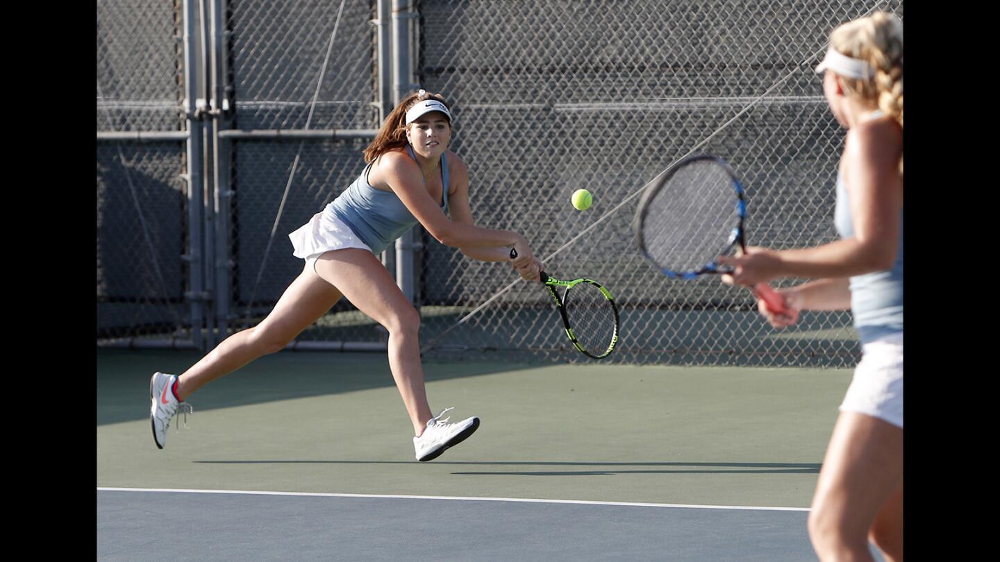 Corona del Mar High No. 2 doubles players Roxy Mackenzie, left, and Shaya Northrup, right, battle against University in the semifinals of the CIF Southern Section Open Division playoffs in Irvine on Wednesday, November 7.