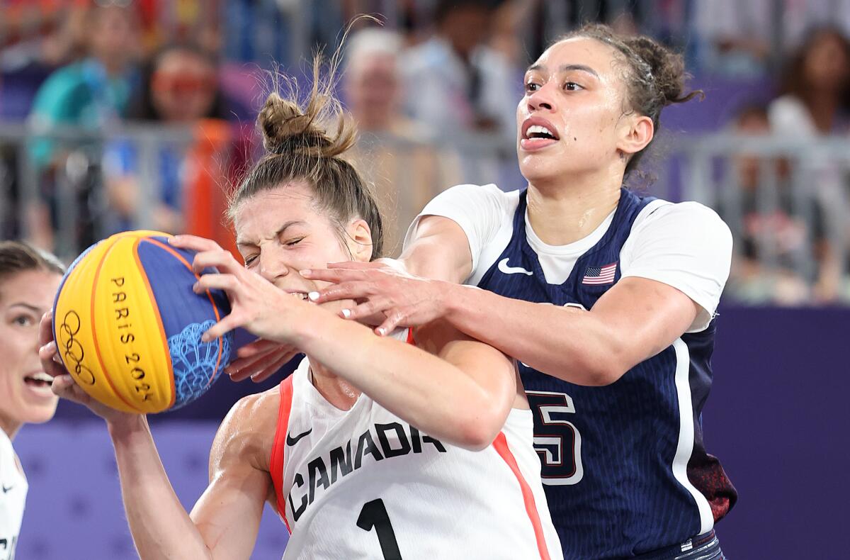 Dearica Hamby tries to steal the ball from Canada's Michelle Plouffe in the 3X3 basketball bronze medal game.