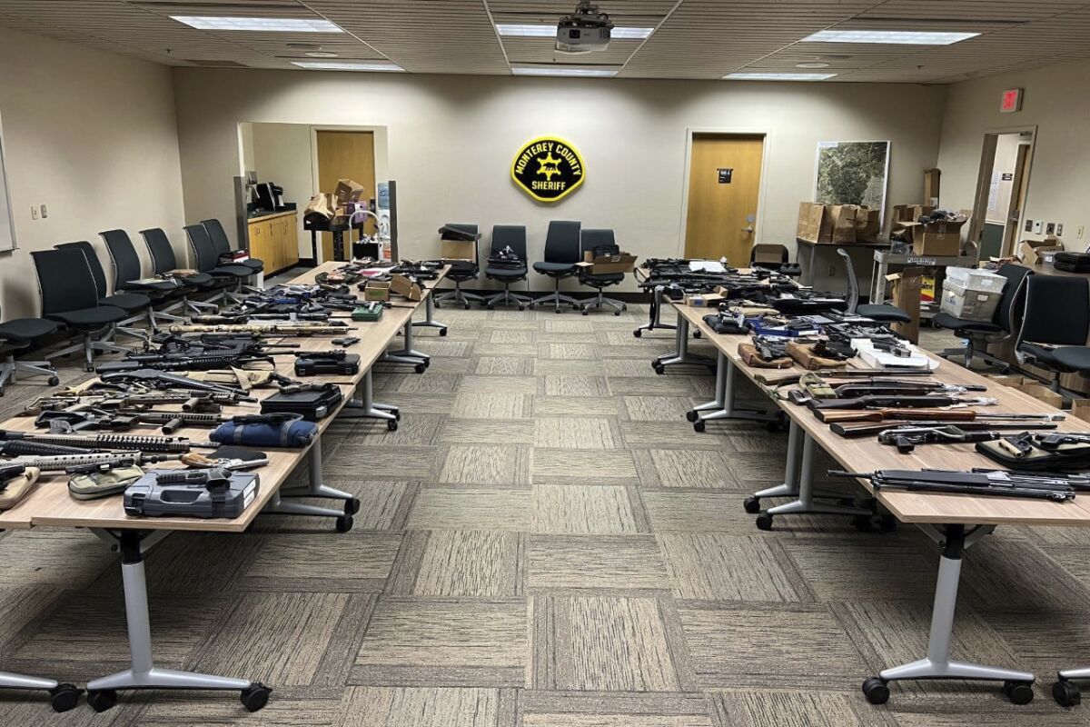 In this photo provided by the Monterey County Sheriff's Office, a cache of weapons seized at the Pebble Beach, Calif., home of Michael Abbott last week, are displayed. Detectives investigating the sexual abuse of a teenage girl seized over 80 firearms and more than 50,000 rounds of ammunition after serving a search warrant at the home of the suspect, Michael Abbott, 55, who was arrested, Sunday, Feb. 27, 2022, authorities said. (Monterey County Sheriff's Office via AP)
