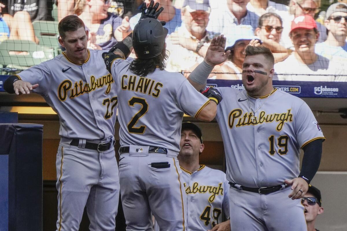 Pittsburgh Pirates' Michael Chavis is congratulated after hitting a home run during the sixth inning of a baseball game against the Milwaukee Brewers Sunday, July 10, 2022, in Milwaukee. (AP Photo/Morry Gash)