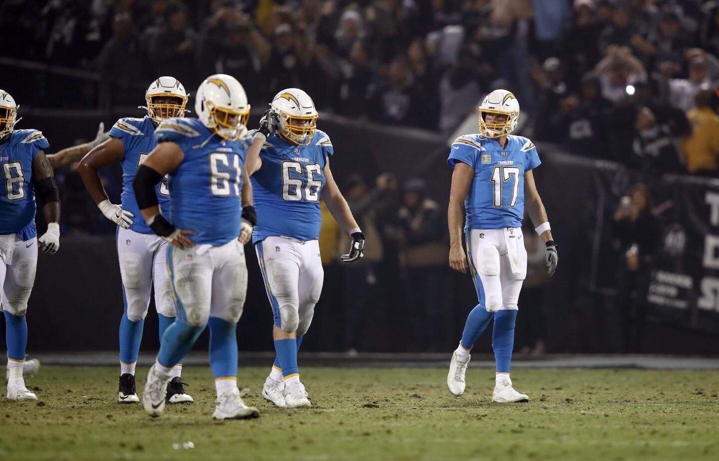 Chargers quarterback Philip Rivers walks off the field after his pass was intercepted late in the fourth quarter of a game Nov. 7 against the Raiders at RingCentral Coliseum.