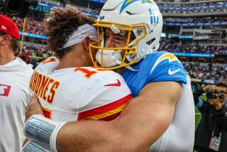 The Chargers' Justin Herbert (10) hugs the Chiefs' Patrick Mahomes after their AFC West game.