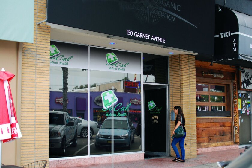 A woman enters So Cal Holistic Health, a medical marijuana dispensary in Pacific Beach. Dispensaries are operating illegally in the city of San Diego and most give little outward indication of what they sell.