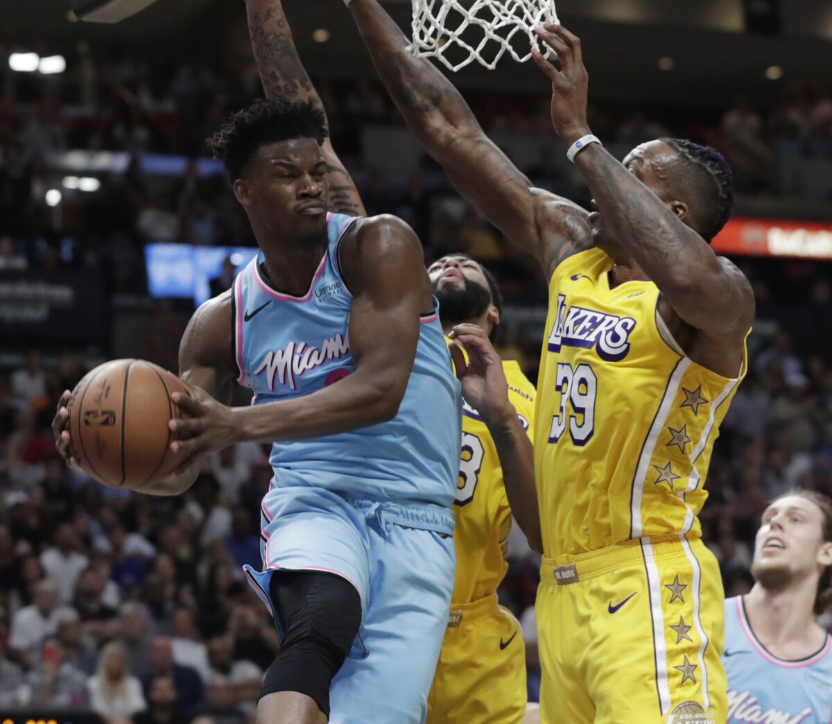 The Heat's Jimmy Butler looks to pass against Lakers defenders Dwight Howard (39) and Anthony Davis during a game Dec. 13.