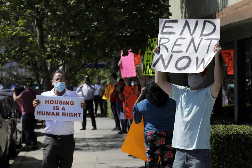 LOS ANGELES, CA - MAY 05: A housing rights and anti-eviction protest outside the office of attorney Dennis Block in Valley Village on Tuesday, May 5, 2020, attracted about 35 protesters. Block has evicted more than 200,000 tenants since 1976, according to the AIDS Healthcare Foundation, the parent of nonprofit Housing is a Human Right and Healthy Housing Foundation, the organizers of the protest. (Myung J. Chun / Los Angeles Times)