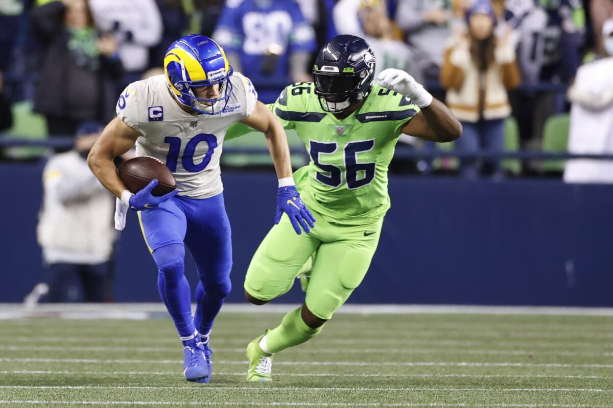 Rams wide receiver Cooper Kupp runs with the ball ahead of Seattle Seahawks linebacker Jordyn Brooks.
