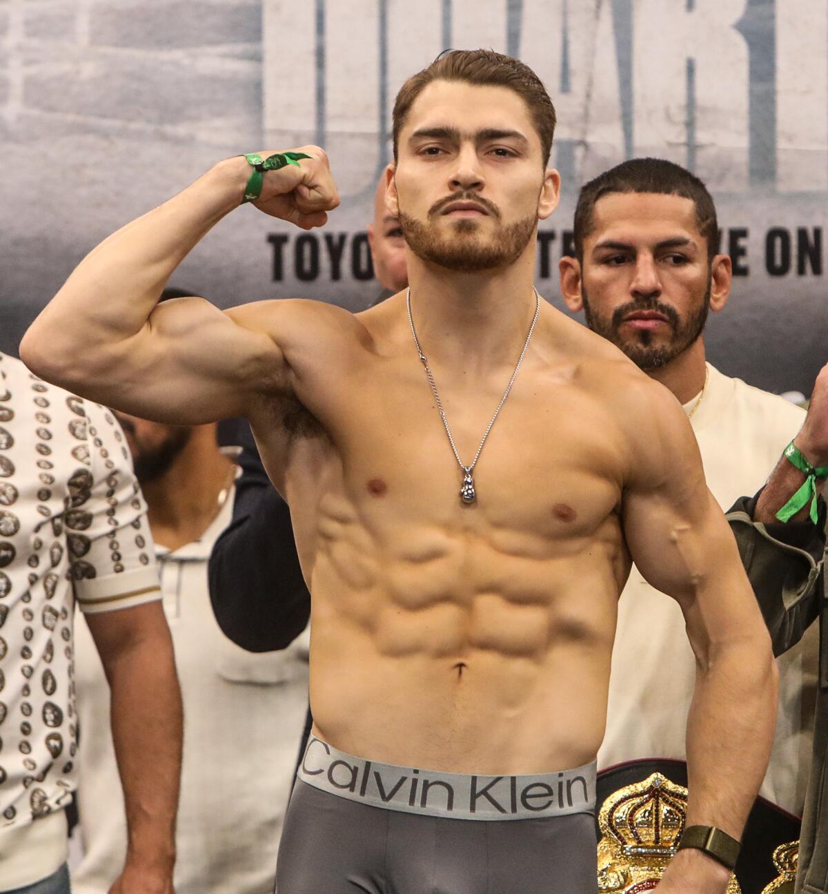 Oscar Duarte flexes one arm and poses for a photo during a ceremonial weigh-in on Friday 