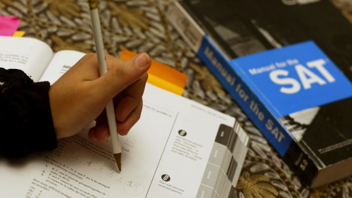 A college applicant uses an SAT preparation book to study for the test on March 6, 2014, in Pembroke Pines, Fla.