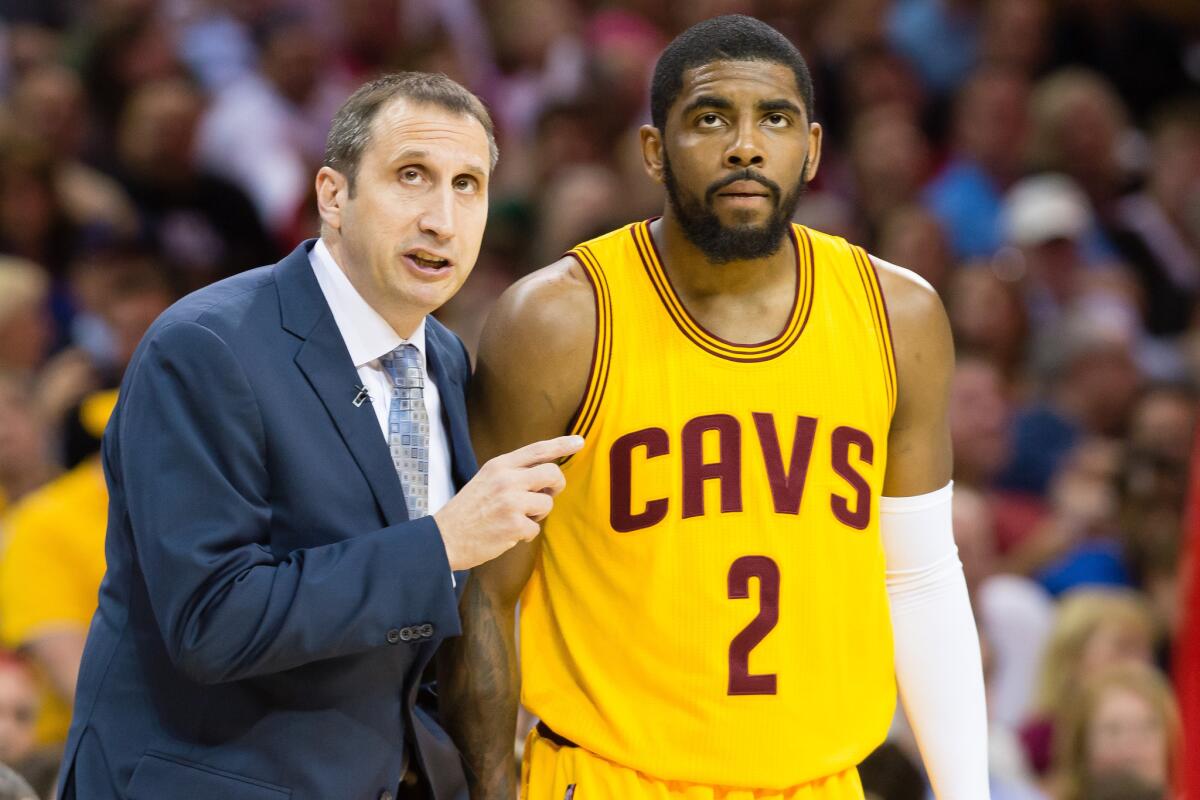Cavaliers Coach David Blatt talks with point guard Kyrie Irving. Irving expects to play against the Hawks in Game 1 after missing end of clincher against Bulls.