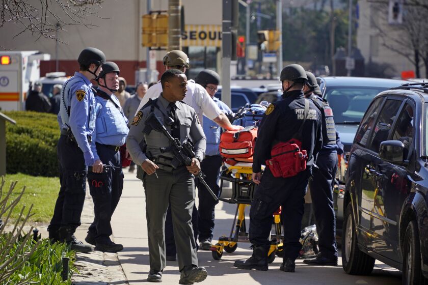 Pittsburgh Police and paramedics respond to Pittsburgh Central Catholic High School for what turned out to be a hoax report of an active shooter, on Wednesday, March 29, 2023 in the Oakland neighborhood of Pittsburgh. (AP Photo/Gene J. Puskar)