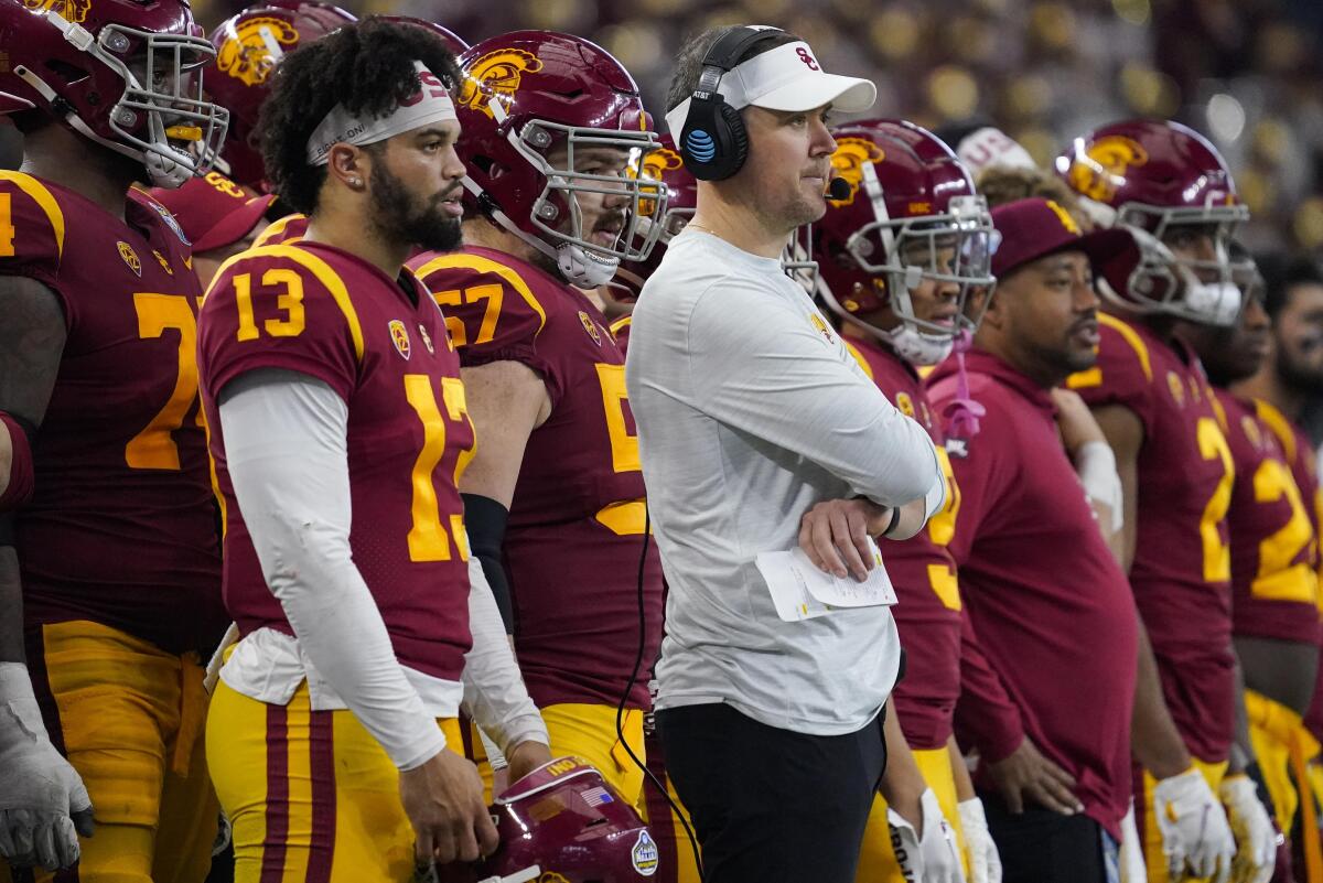 USC quarterback Caleb Williams and coach Lincoln Riley watch play during the Cotton Bowl game against Tulane.