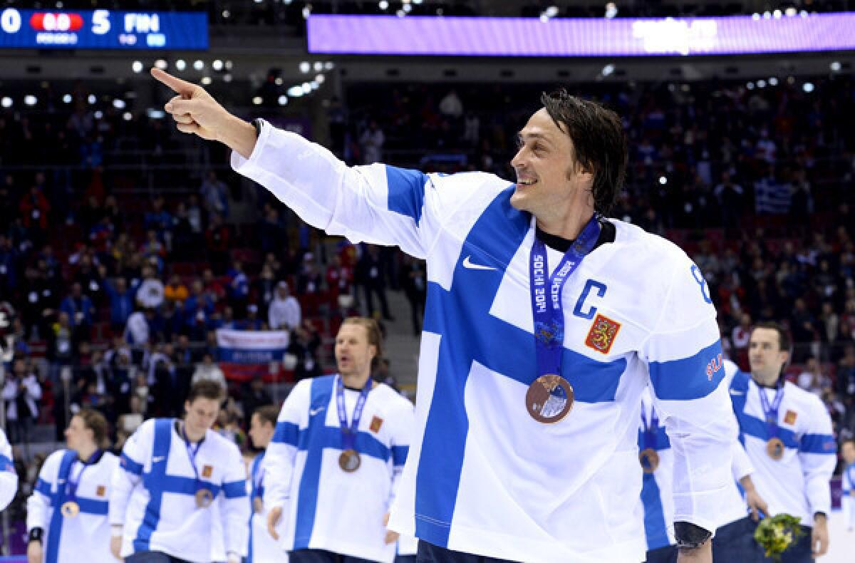Finland captain Teemu Selanne celebrates along with teammates after their 5-0 victory over the U.S. in the bronze-medal men's hockey game Saturday at the Bolshoy Ice Dome.