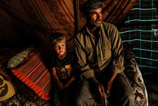 WADI TIRAN, OCCUPIED WEST BANK -- NOVEMBER 30, 2023: Bassam Al ZaOarir, 55, poses for a portrait with his 4-year-old son Amer, in their village Wadi Tiran which is constantly harassed and intimidated with violence by nearby Jewish settlers, in the South Hebron Hills of the Occupied West Bank, Thursday, Nov. 30, 2023. As IsraelOs war against Hamas in Gaza unfolds amid the bombed buildings and deaths of more than 11,000 Palestinians, the increasing violence in the West Bank, which has been occupied by Israel since its 1967 war with Arab nations, is threatening to open another front in the conflict. Armed settlers man checkpoints and at times descend on Palestinian lands destroying hundreds of olive trees and blocking villages in deadly provocations that have led to retaliatory knifings and ambush shootings by Palestinians. (MARCUS YAM / LOS ANGELES TIMES)