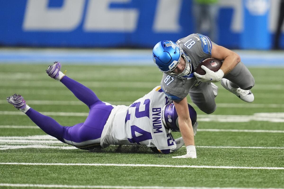 Detroit Lions tight end Sam LaPorta is tackled by Minnesota Vikings safety Camryn Bynum during a game on Jan. 7.