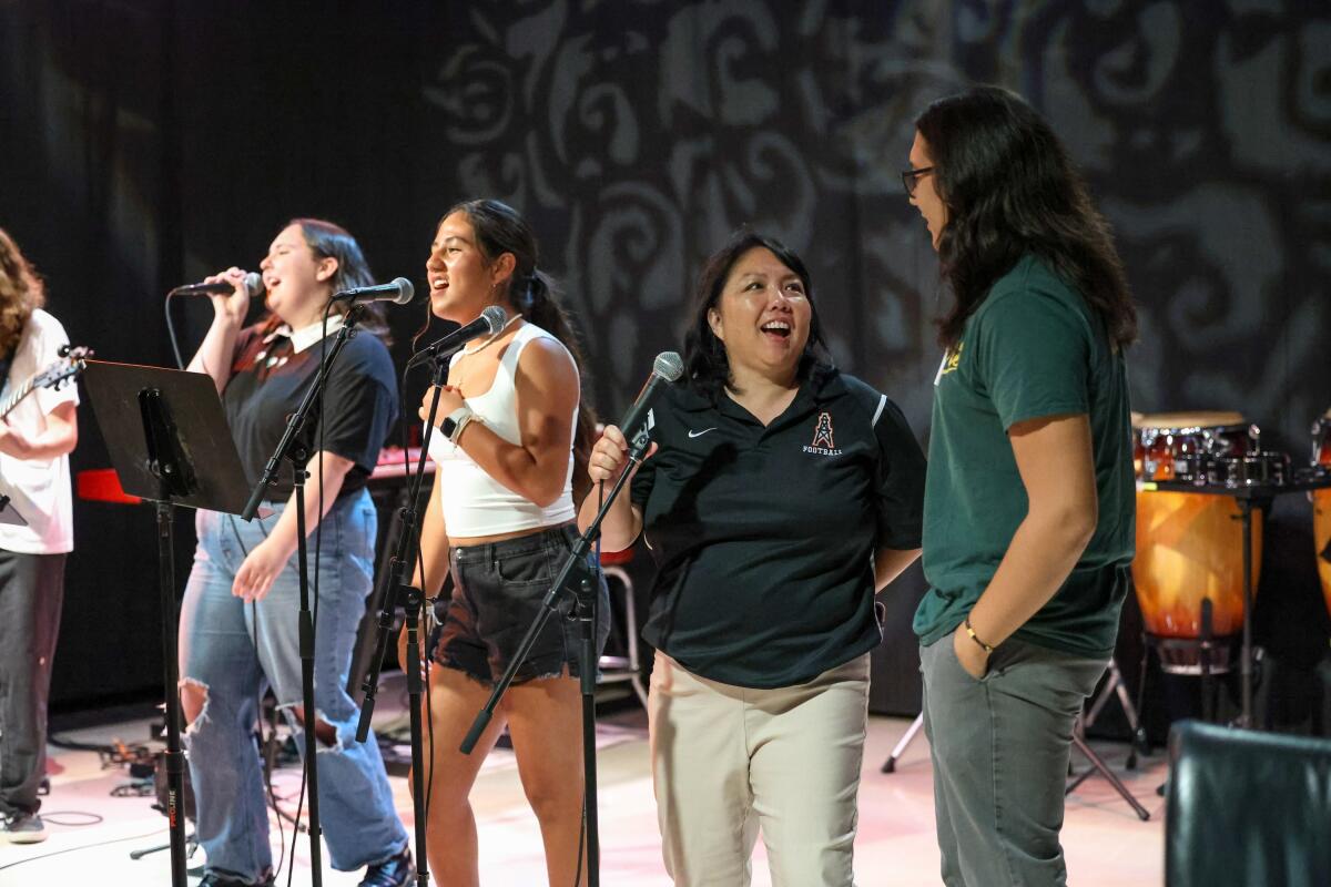 New Huntington Beach Union High School District Supt. Carolee Ogata performs with HBAPA students.