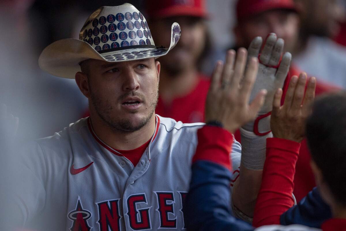 Angels star Mike Trout celebrates in the dugout after hitting a two-run home run against the Cleveland Guardians.