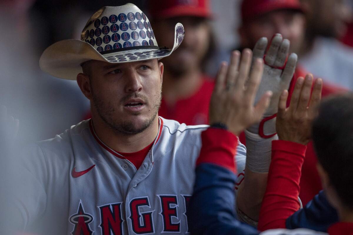 Angels slugger Mike Trout celebrates in the dugout after hitting a two-run home run.