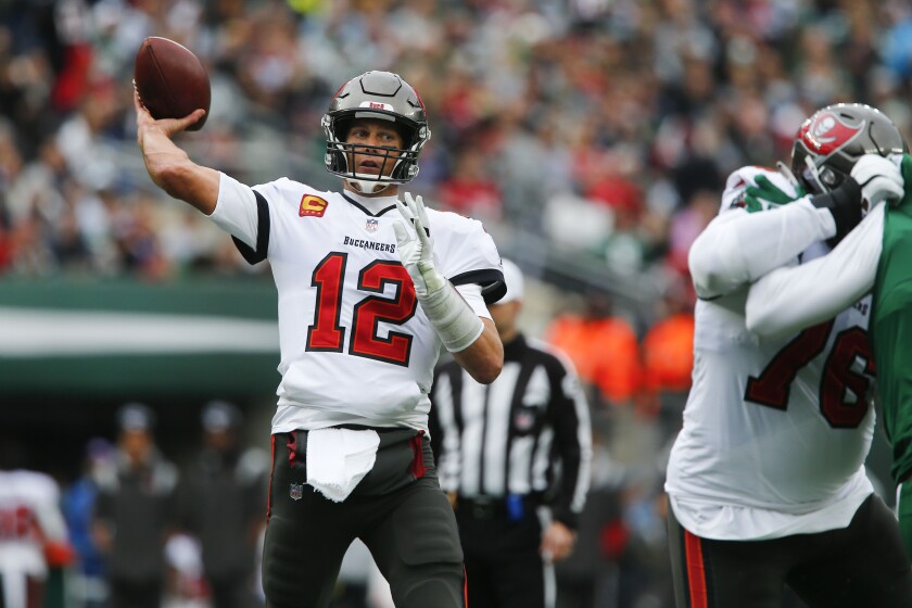 Tampa Bay Buccaneers quarterback Tom Brady, left, throws during the first half of an NFL football game against the New York Jets, Sunday, Jan. 2, 2022, in East Rutherford, N.J. (AP Photo/John Munson)