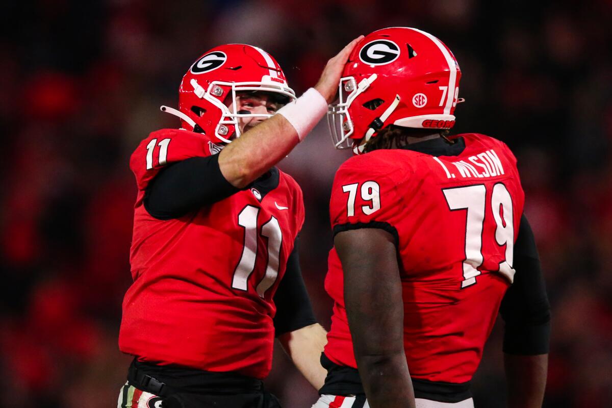 Georgia quarterback Jake Fromm (11) celebrates with Isaiah Wilson (79) during the second half against Missouri on Saturday. The Bulldogs have a big game Saturday against Auburn.