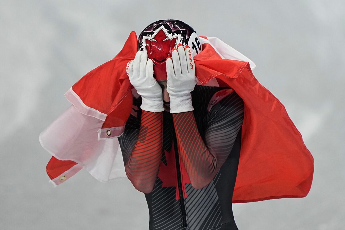 Steven Dubois of Canada, reacts after his second place finish in the men's 1500-meters final during the short track speedskating competition at the 2022 Winter Olympics, Wednesday, Feb. 9, 2022, in Beijing. (AP Photo/David J. Phillip)