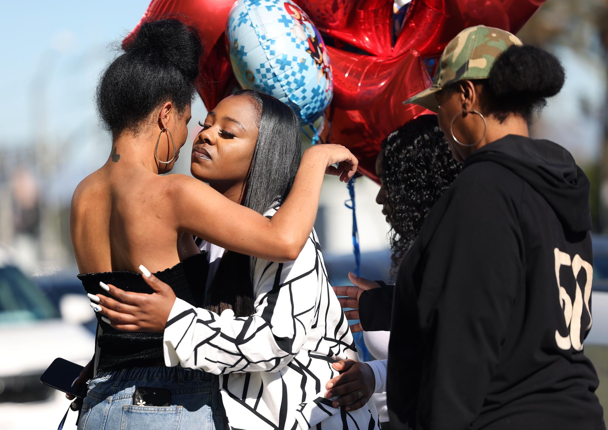 Creole Green (center), 31, is comforted by relatives outside Compton City Hall on December 7, 2024.