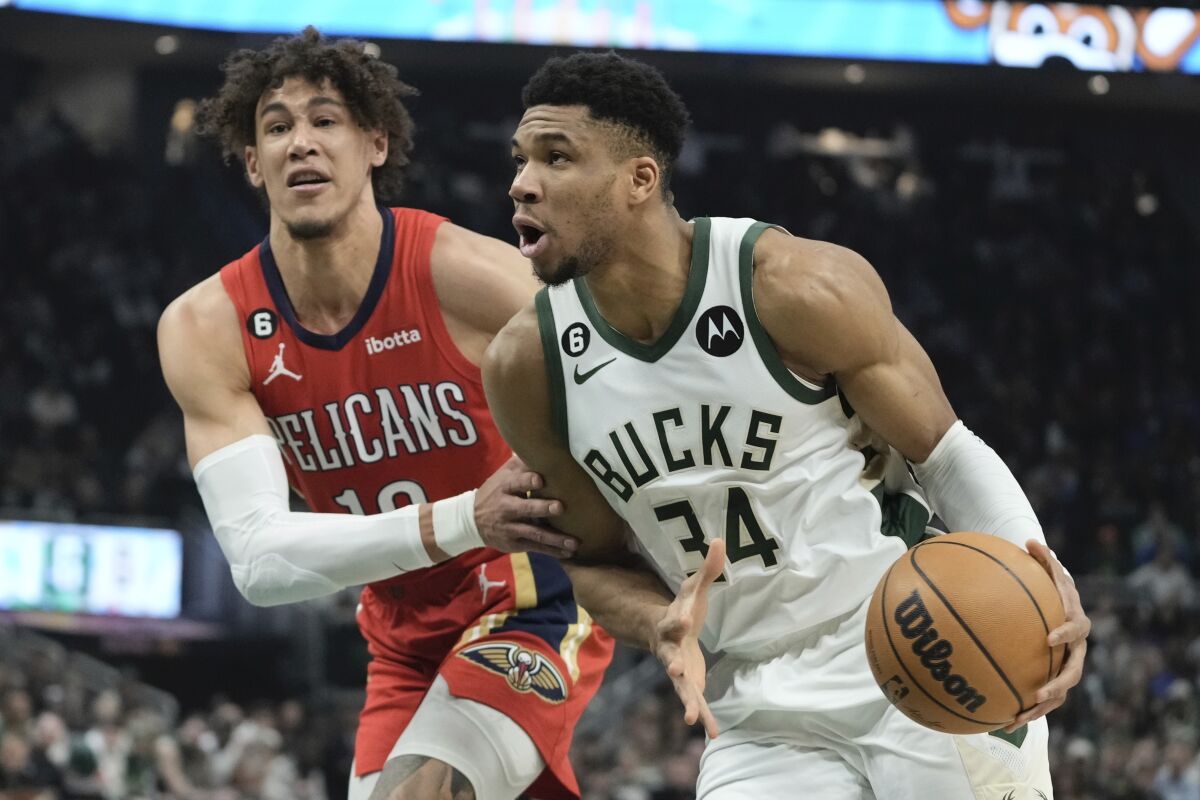 Milwaukee Bucks' Giannis Antetokounmpo drives past New Orleans Pelicans' Jaxson Hayes during the first half of an NBA basketball game Sunday, Jan. 29, 2023, in Milwaukee. (AP Photo/Morry Gash)