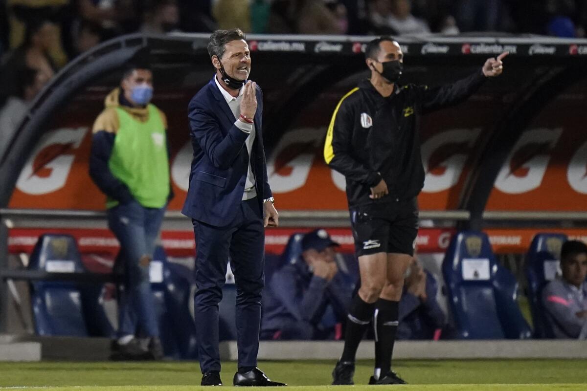 Atlas FC coach Diego Cocca gives instructions to his players.