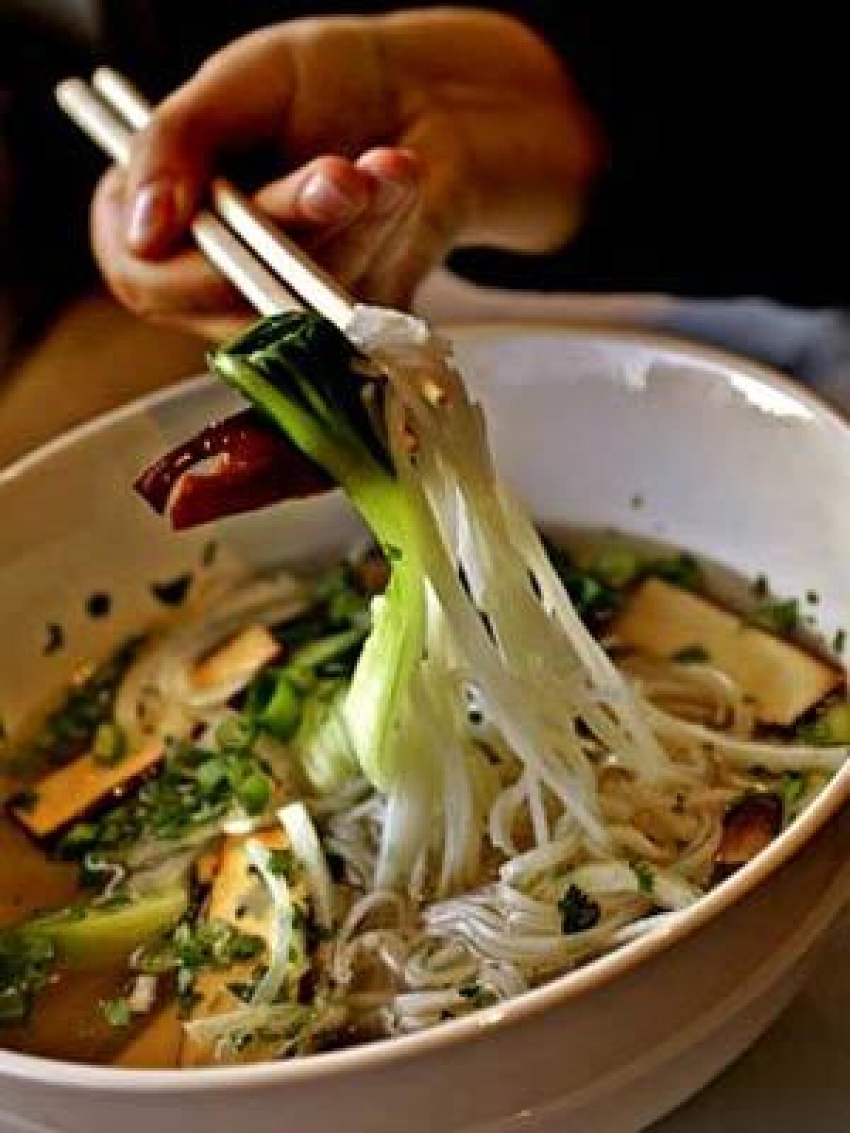 Pho Chay, tofu, and straw mushrooms, onions, bok-choy, bean sprouts, basil and noodles served in a vegetable broth.