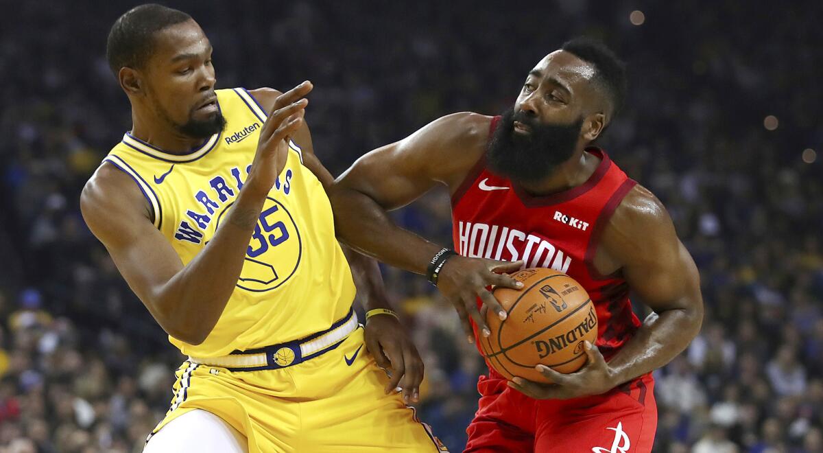 Warriors forward Kevin Durant tries to cut off a drive by Rockets guard James Harden during a game earlier this season.