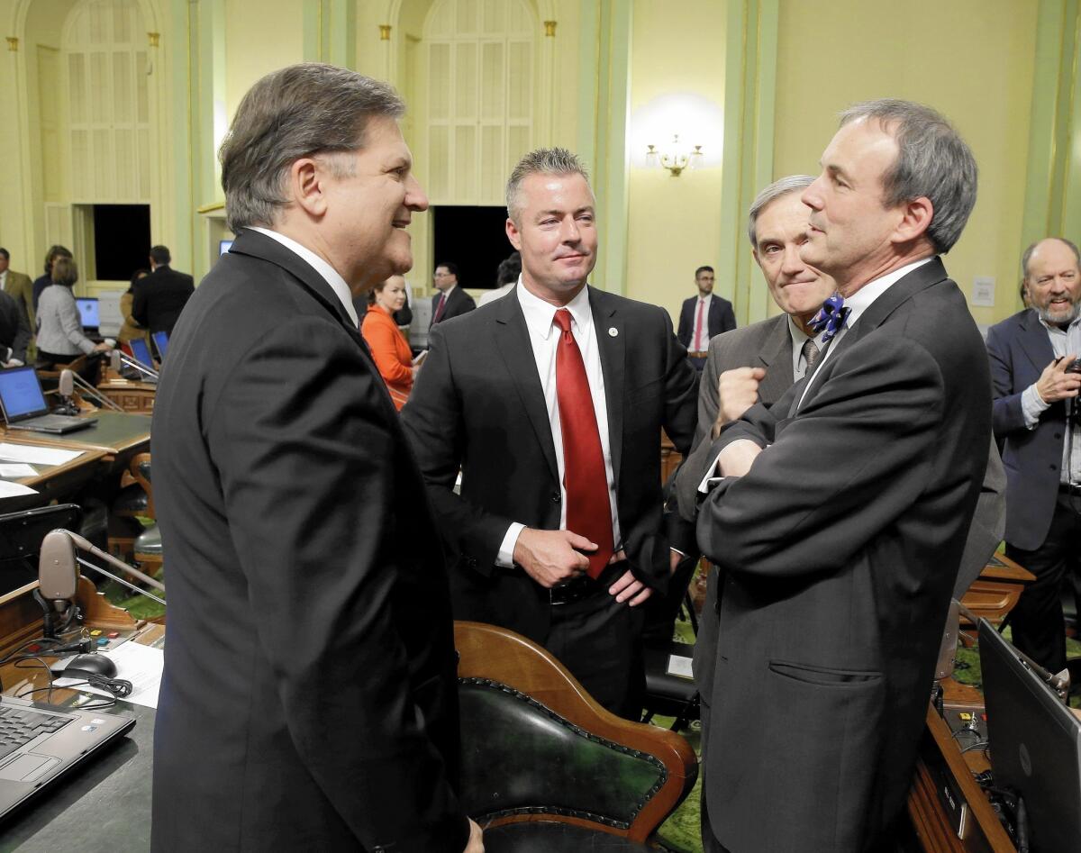 GOP Assemblyman Travis Allen, in red tie, with Democratic state Sen. Bob Hertzberg, left, and Charles Munger Jr., far right, in 2014.
