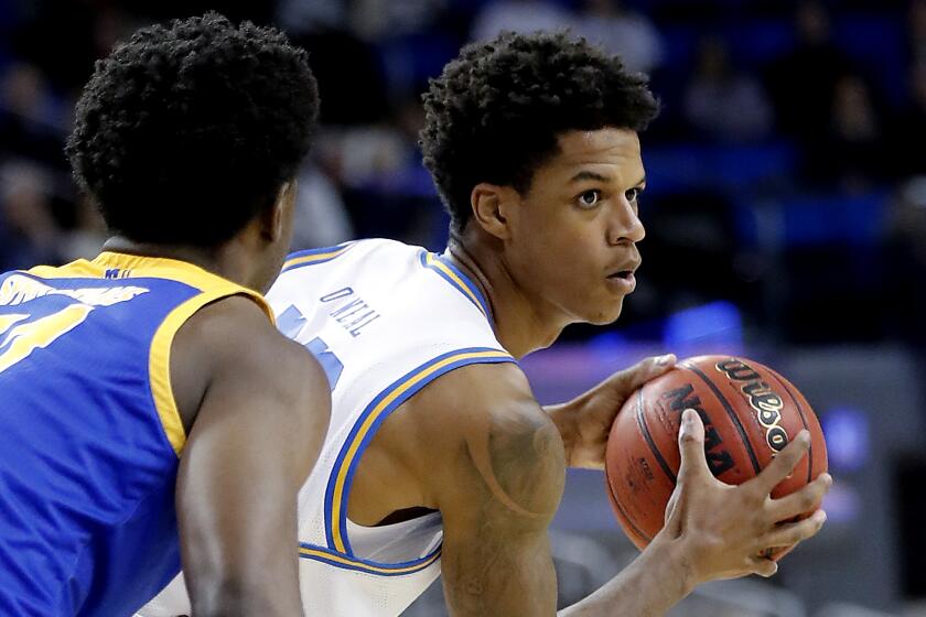 LOS ANGELES, CALIF. - DEC. 1, 2019. Bruins forward Shareef O'Neal looks for an open man inside while defended by San Jose State forward Christian Anigwe in the second half at Pauley Pavilion in Los Angeles on Sunday, Dec. 1, 2019. (Luis Sinco/Los Angeles Times)